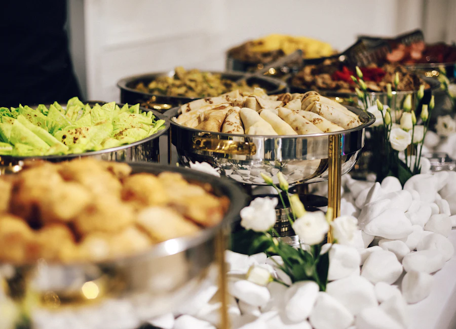 Buffet of vegetarian dishes served in polished chafing dishes at a family function